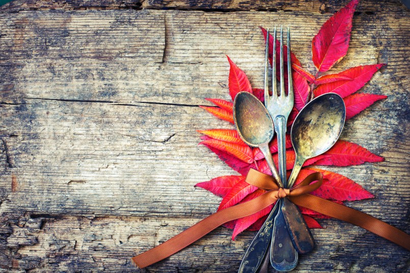Thanksgiving table setting: cutlery on the autumn background with autumn leaves,ribbon on wooden background:Thanksgiving holidays background concept