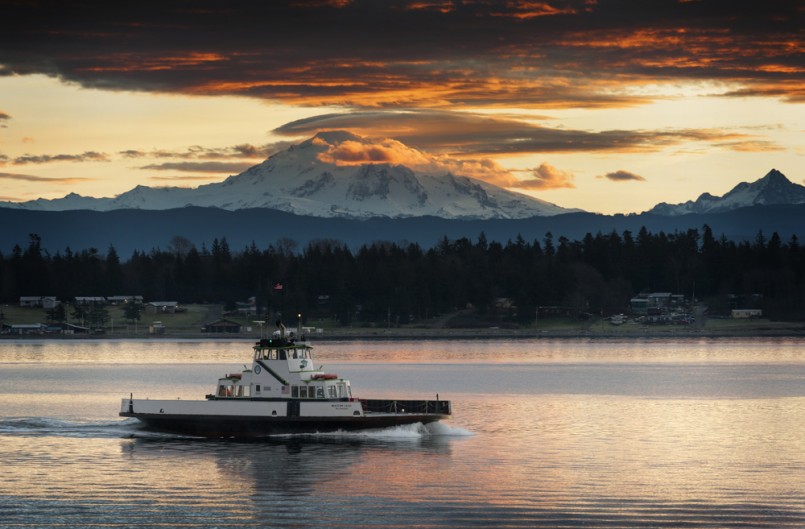 Ferry and Mt. Baker. The ferryboat "Whatcom Chief" sails from Gooseberry Point to Lummi Island across Hales Pass in the San Juan Islands of Puget Sound. Mt. Baker is seen in the background at sunrise.