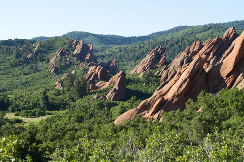 Red sandstone cliffs with green forest below