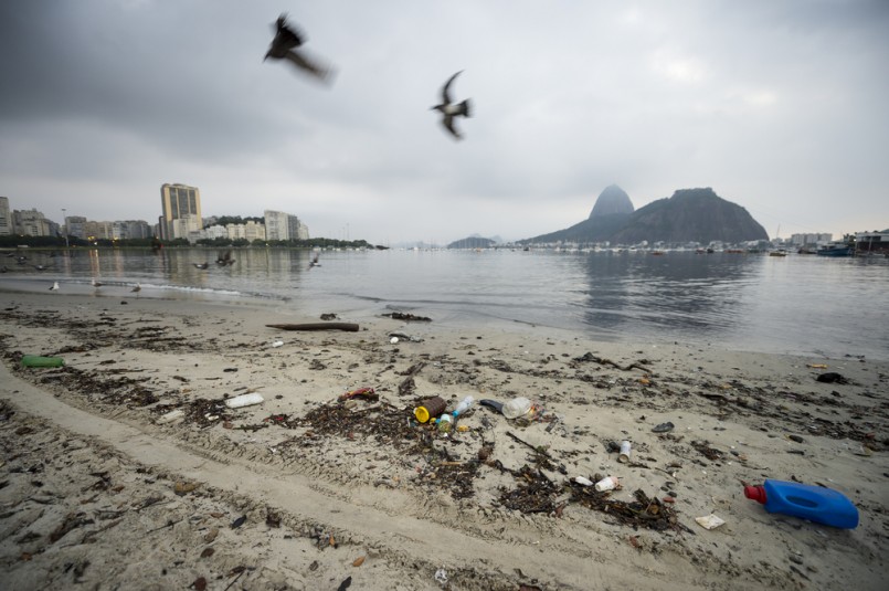 Garbage and pollution from Guanabara Bay wash ashore on Botafogo Beach in front of Sugarloaf Mountain in an ongoing concern for the summer Olympic Games.