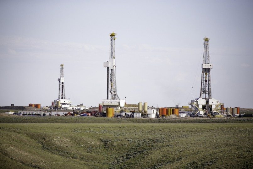 Three hydro-fracking derricks sitting on a plain