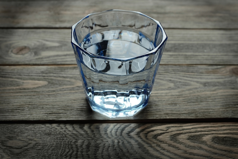 glass of water on the table wooden background