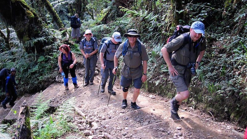 group of tired hikers climbing mt kilimanjaro in africa